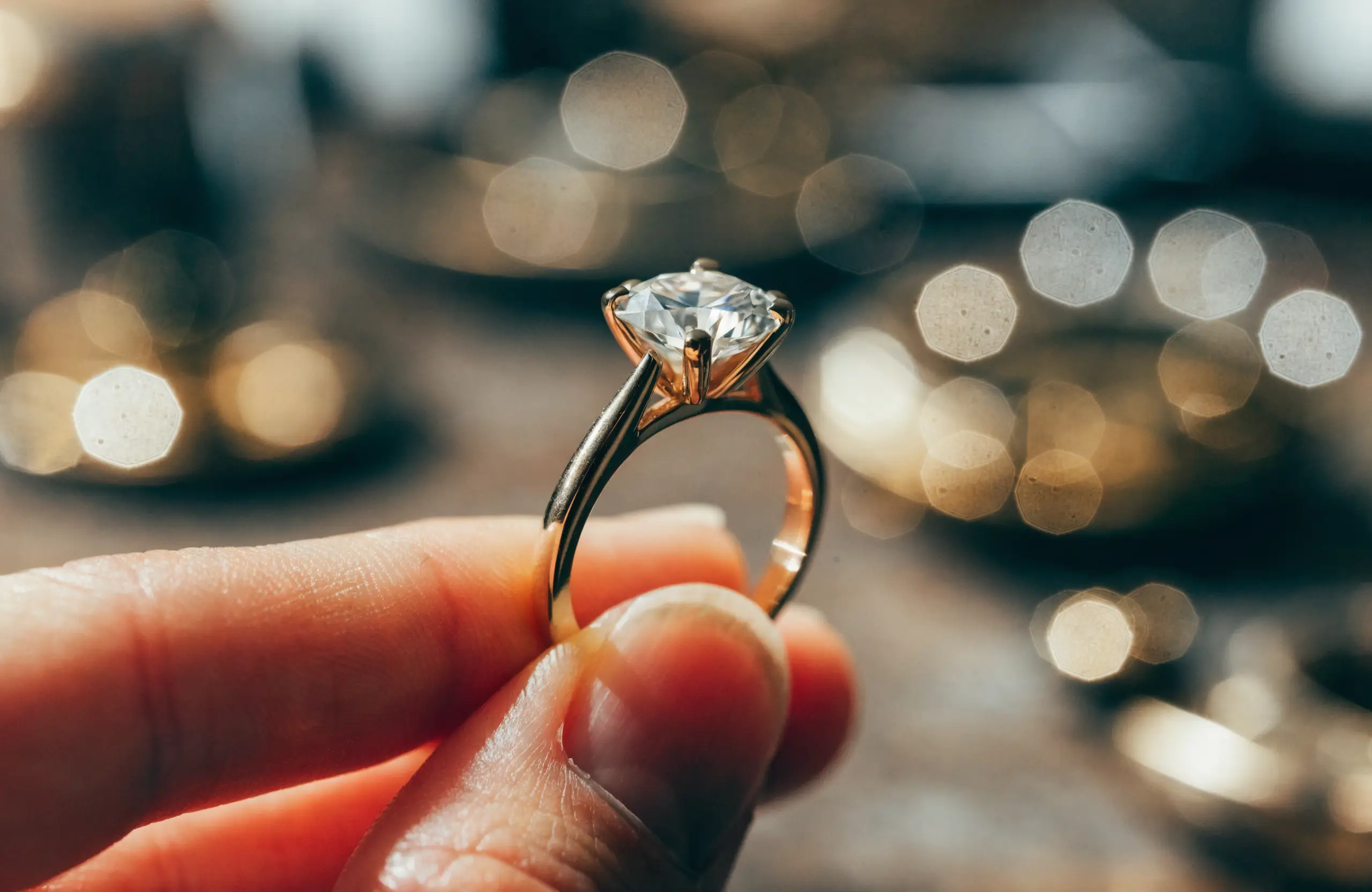 A custom diamond solitaire engagement ring in yellow gold